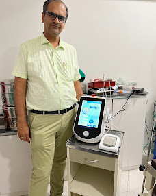Dr. Urvish Doshi with medical equipment at the clinic